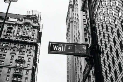 street sign pointing Wall Street